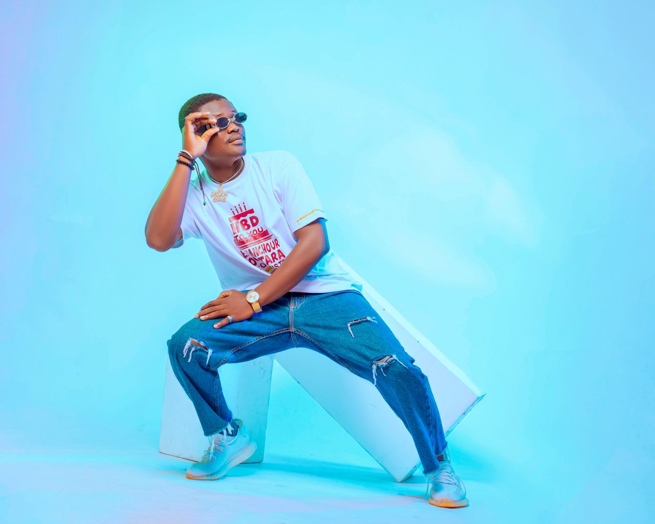 Crafting Captivating Headlines: Your awesome post title goes here Fashionable young man in casual attire posing confidently in a studio.