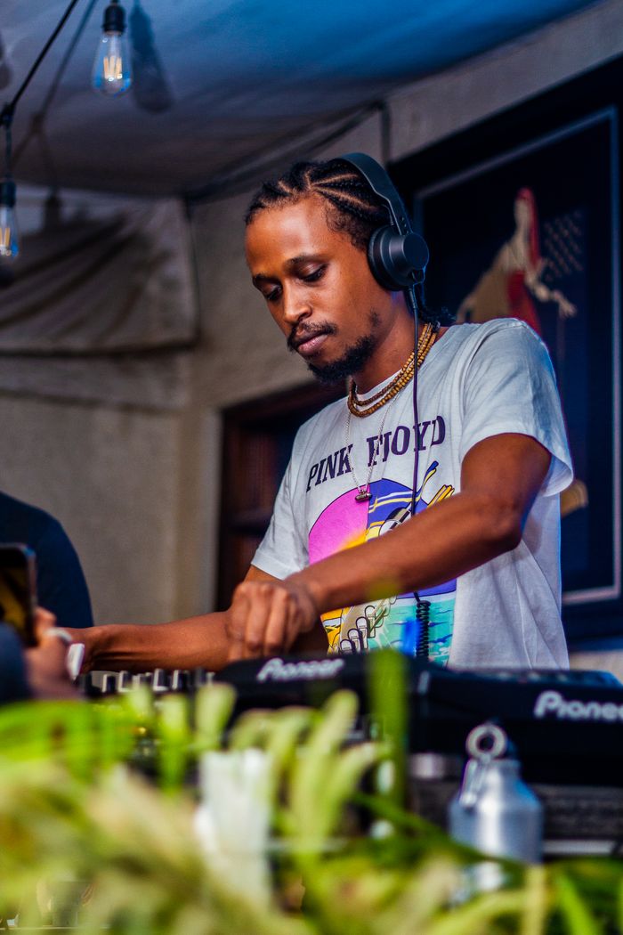 A DJ expertly mixing tracks during an indoor music event in Nairobi, Kenya.